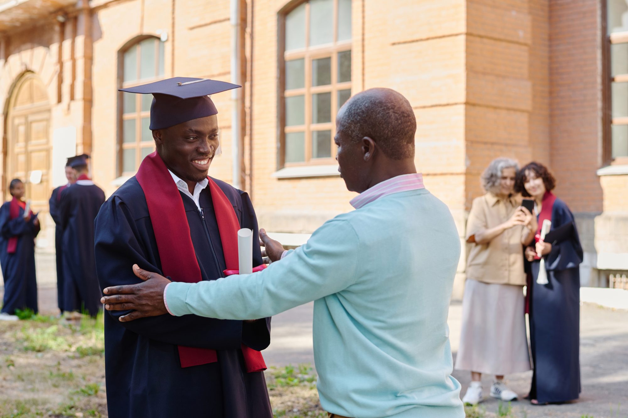 A graduate celebrating with family on graduation day
